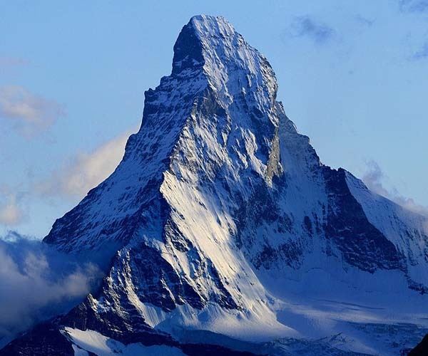 A high-altitude shot of the Swiss Alps with mountaineers.