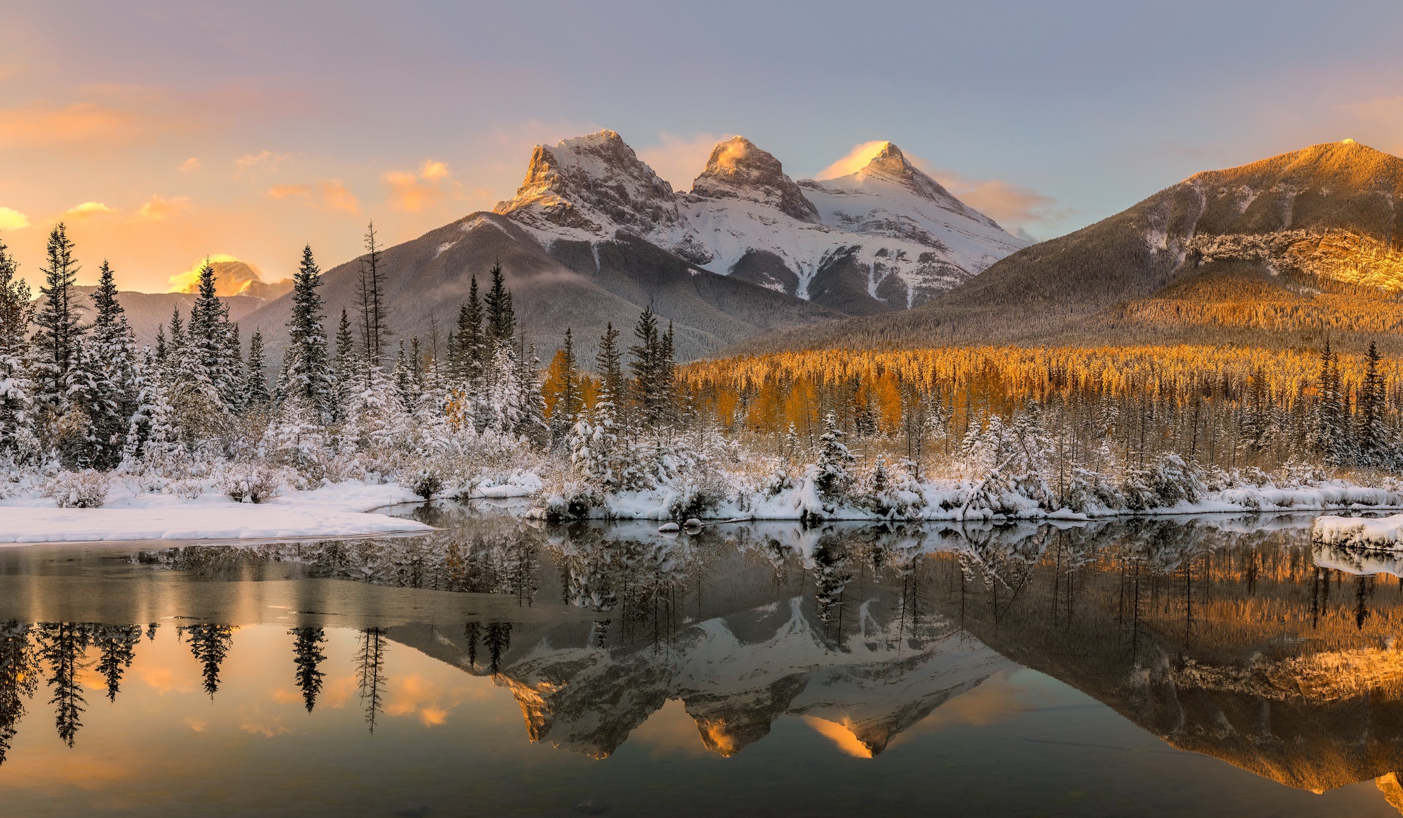 Cyclists riding on a winding road through the Canadian Rockies.